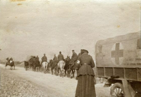 Muriel Thompson with Red Cross Ambulance and Belgians on road near La Paune